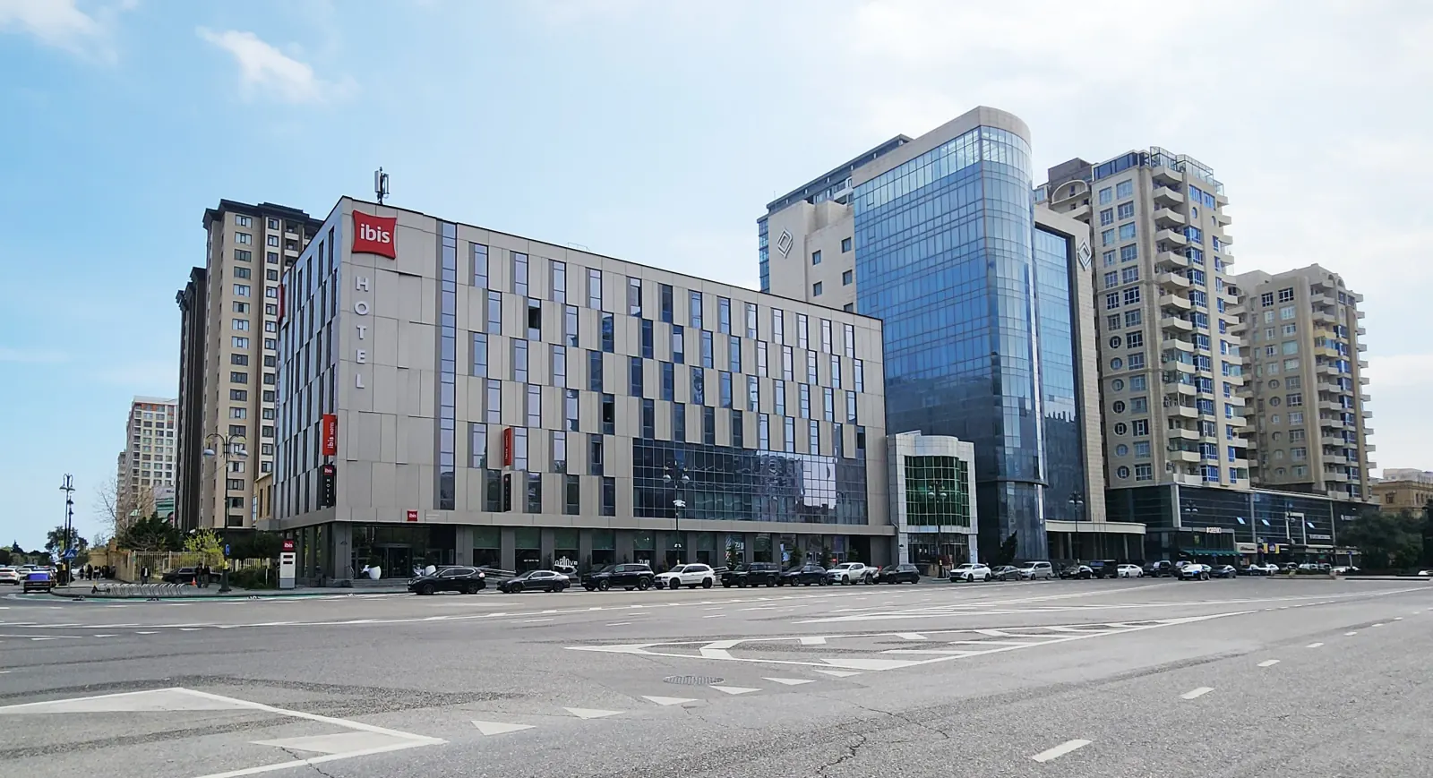 Ibis Baku City — Ibis Baku City hotel building exterior at dusk with architectural lighting highlighting facade geometry